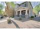 Charming two-story home featuring a covered front porch with stone accents and a well-maintained landscaped yard at 34979 N 30Th Ave, Phoenix, AZ 85086
