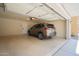 Spacious two-car garage featuring speckled epoxy flooring, a SUV, and an automatic door opener at 34979 N 30Th Ave, Phoenix, AZ 85086