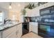 Modern kitchen with black appliances, granite counters, and decorative plants at 34979 N 30Th Ave, Phoenix, AZ 85086