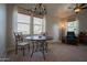 Bright living area featuring a dining table with seating, large windows, and a comfortable leather recliner at 34979 N 30Th Ave, Phoenix, AZ 85086