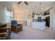 Open-concept living area with a view of the kitchen, featuring natural light, furniture, and neutral decor at 34979 N 30Th Ave, Phoenix, AZ 85086