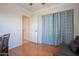 Bright living room featuring hardwood floors, a futon, a desk with curtains, and a ceiling fan at 34979 N 30Th Ave, Phoenix, AZ 85086