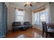 Versatile space with hardwood floors, two futons, a desk, and bright windows with natural light at 34979 N 30Th Ave, Phoenix, AZ 85086