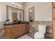 Well-lit bathroom featuring a wooden vanity, vessel sink, stylish tiling, and modern fixtures at 37334 N 17Th Ave, Phoenix, AZ 85086