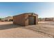 External view of a one-car detached garage with a roll up door and desert landscaping around the building at 37334 N 17Th Ave, Phoenix, AZ 85086