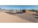 External view of a one-car detached garage with a roll up door and ample parking and desert landscaping at 37334 N 17Th Ave, Phoenix, AZ 85086
