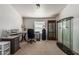 Office space with a neutral carpet, functional desk area, storage, and a glass display cabinet at 37334 N 17Th Ave, Phoenix, AZ 85086