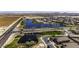 Beautiful aerial view of the community with a lake, green spaces, and well-maintained homes at 37390 W Merced St, Maricopa, AZ 85138