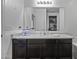 Modern bathroom featuring spacious counter space, dark cabinets and large mirror at 37390 W Merced St, Maricopa, AZ 85138