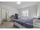 This spacious bedroom includes a large window, comfortable queen bed, and an adjacent bathroom at 37390 W Merced St, Maricopa, AZ 85138