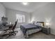 Relaxing bedroom with neutral carpet, a large window, and a queen-sized bed with side tables at 37390 W Merced St, Maricopa, AZ 85138