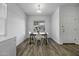 Bright dining area features modern light fixture, wood-style flooring, and bright view at 37390 W Merced St, Maricopa, AZ 85138