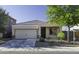 Charming single-story home featuring a well-maintained front yard and a two-car garage at 37390 W Merced St, Maricopa, AZ 85138
