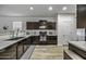 Well-equipped kitchen with dark cabinetry, modern countertops, and a practical layout at 37390 W Merced St, Maricopa, AZ 85138