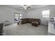 Relaxing living room area offers lots of natural light, a ceiling fan and a sliding glass door at 37390 W Merced St, Maricopa, AZ 85138