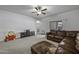 Spacious living room features a neutral color palette, with an adjacent entertainment center and sofa at 37390 W Merced St, Maricopa, AZ 85138