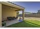 Covered patio with outdoor seating, perfect for relaxation and enjoying the backyard view at 37390 W Merced St, Maricopa, AZ 85138