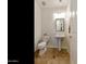 Powder room featuring pedestal sink, toilet, and modern fixtures at 4229 E Nightingale Ln, Gilbert, AZ 85298