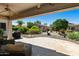 Relaxing covered patio with brick flooring, outdoor seating, and views of a well maintained desert landscaped backyard at 4229 E Nightingale Ln, Gilbert, AZ 85298