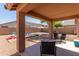 Covered patio with outdoor seating overlooking a large, landscaped backyard at 4817 W St Charles Ave, Laveen, AZ 85339