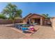 Spacious backyard with colorful play area, patio, and low-maintenance desert landscaping at 4817 W St Charles Ave, Laveen, AZ 85339