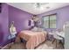 Cozy bedroom featuring purple walls, soft carpet, and a comfortable full-sized bed at 4817 W St Charles Ave, Laveen, AZ 85339