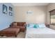 Comfortable bedroom featuring a queen bed, couch, and a window with views of the outdoors at 4817 W St Charles Ave, Laveen, AZ 85339
