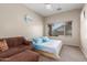Bedroom with a queen bed, a sitting area, and a bright window offering lots of natural light at 4817 W St Charles Ave, Laveen, AZ 85339