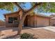 Lovely single-story home with desert landscaping, a shade tree, and a two-car garage at 4817 W St Charles Ave, Laveen, AZ 85339