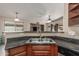 Functional kitchen featuring a breakfast bar, stainless steel sink, and ample countertop space at 4817 W St Charles Ave, Laveen, AZ 85339