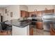 Well-appointed kitchen with wooden cabinets, a breakfast bar, and stainless steel appliances at 4817 W St Charles Ave, Laveen, AZ 85339