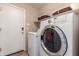 Functional laundry room featuring a washer, dryer and storage shelves with baskets at 4817 W St Charles Ave, Laveen, AZ 85339