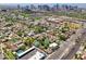 Scenic aerial view of a vibrant residential neighborhood with lush greenery, well-maintained homes, and urban skyline views at 530 W Willetta St, Phoenix, AZ 85003