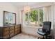 Cozy room with chandelier and large windows offering views, complete with a classic wooden dresser and a desk at 530 W Willetta St, Phoenix, AZ 85003