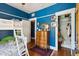 Blue bedroom with bunk bed and closet space, featuring hardwood floors at 530 W Willetta St, Phoenix, AZ 85003