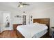 Comfortable bedroom with hardwood floors, featuring a queen-size bed and ensuite bathroom at 530 W Willetta St, Phoenix, AZ 85003