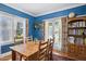 Inviting dining area with hardwood floors, bright windows, blue walls, and stylish curtains at 530 W Willetta St, Phoenix, AZ 85003