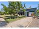 Charming home with mature trees, lush lawn, a gated carport, and vibrant landscaping at 530 W Willetta St, Phoenix, AZ 85003