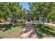 Inviting home with a tile walkway, mature trees, a well-maintained lawn, and beautiful landscaping at 530 W Willetta St, Phoenix, AZ 85003