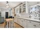 Bright kitchen with white cabinetry, subway tile backsplash, and a functional island seating area at 530 W Willetta St, Phoenix, AZ 85003