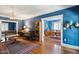 Stylish living room featuring hardwood floors, blue walls, a decorative rug, and an open doorway at 530 W Willetta St, Phoenix, AZ 85003