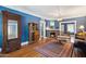 Cozy living room boasts hardwood floors, blue walls, a brick fireplace, and vintage furnishings at 530 W Willetta St, Phoenix, AZ 85003