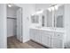 Bright bathroom boasts dual sinks, spacious vanity with modern hardware and a separate room for added privacy at 6368 W Firebird Dr, Glendale, AZ 85308