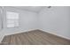 Bright, airy bedroom with wood-look floors and natural light from a window creates a calm and inviting space at 6368 W Firebird Dr, Glendale, AZ 85308