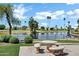 Beautiful view of lake with palm trees and community homes in the background, featuring patio seating at 6368 W Firebird Dr, Glendale, AZ 85308