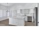 Bright kitchen showcasing a center island, stainless steel appliances, and light countertops at 6368 W Firebird Dr, Glendale, AZ 85308