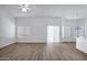 Bright and spacious living area with wood-look floors, modern lighting, and an open layout at 6368 W Firebird Dr, Glendale, AZ 85308