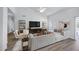 Sleek living room boasts a modern TV set up, sectional sofa, and bright neutral palette at 6368 W Firebird Dr, Glendale, AZ 85308