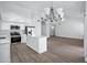 Spacious living room with a functional kitchen and breakfast nook adjacent at 6368 W Firebird Dr, Glendale, AZ 85308