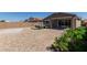 Spacious backyard featuring a hot tub, low-maintenance rock landscaping, and covered patio at 7620 W Pioneer St, Phoenix, AZ 85043